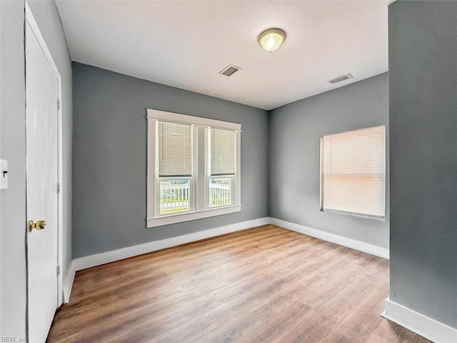 interior space featuring wood finished floors, visible vents, and baseboards