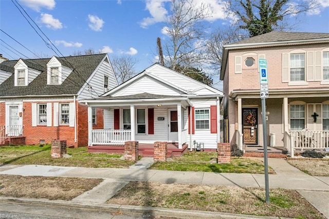 view of front of property featuring covered porch, brick siding, and crawl space