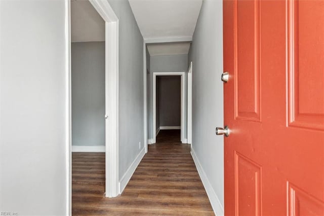 hall with dark wood finished floors and baseboards