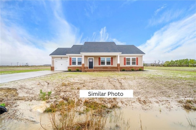 view of front of house with a garage, driveway, and brick siding