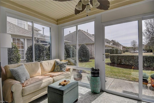 sunroom / solarium with a ceiling fan