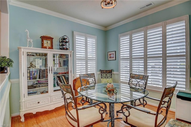 dining room featuring ornamental molding and visible vents