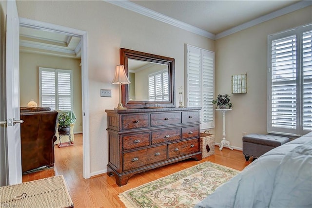 bedroom with light wood-style floors, crown molding, and baseboards