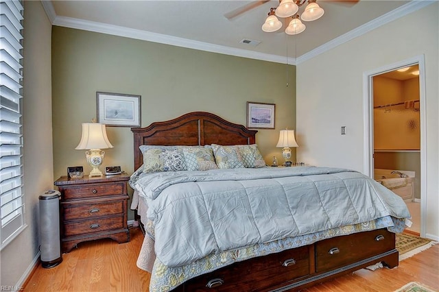 bedroom with baseboards, crown molding, visible vents, and wood finished floors