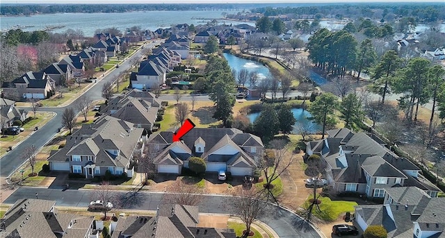 birds eye view of property featuring a residential view and a water view