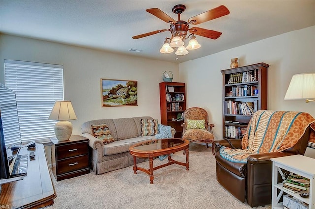 living room featuring carpet floors, ceiling fan, and visible vents