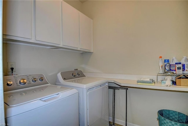 washroom featuring cabinet space and washing machine and dryer