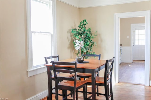 dining space featuring plenty of natural light and wood finished floors