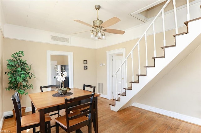 dining area featuring ceiling fan, visible vents, baseboards, stairs, and light wood-style floors