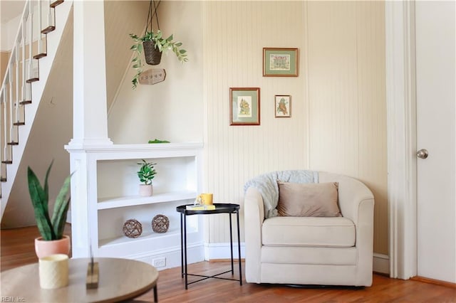 sitting room featuring stairs and wood finished floors