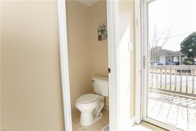 bathroom with toilet and tile patterned floors