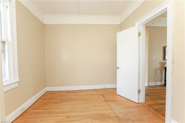 unfurnished room with light wood-style flooring and baseboards