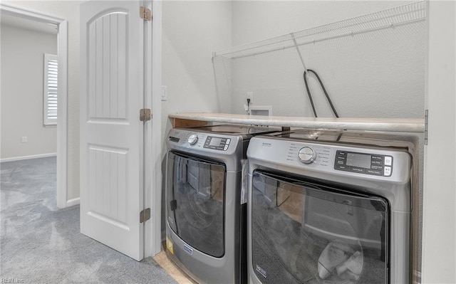 laundry room with laundry area, independent washer and dryer, carpet flooring, and baseboards