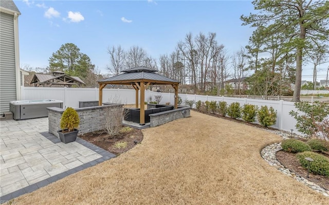 view of yard with a gazebo, a patio area, a fenced backyard, and a hot tub