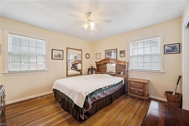 bedroom featuring ceiling fan, wood finished floors, and baseboards