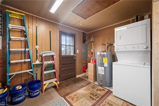 basement featuring stacked washer and dryer, electric panel, wood walls, and electric water heater