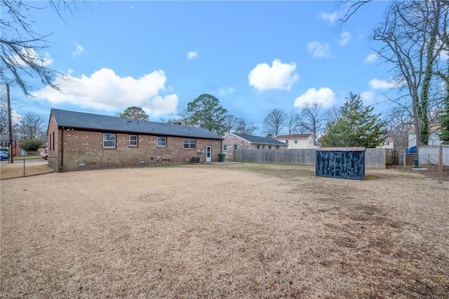 view of yard with a fenced backyard and an outdoor structure