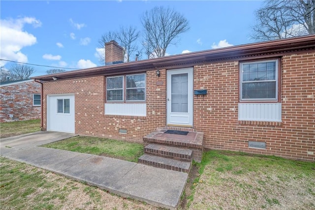 ranch-style home with crawl space, brick siding, and a chimney