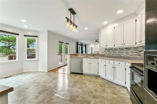 kitchen with electric range, white cabinets, dishwasher, a peninsula, and backsplash