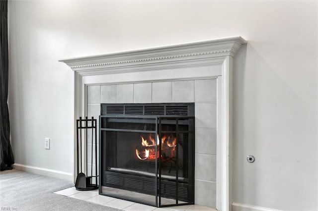 details featuring carpet floors, a fireplace, and baseboards