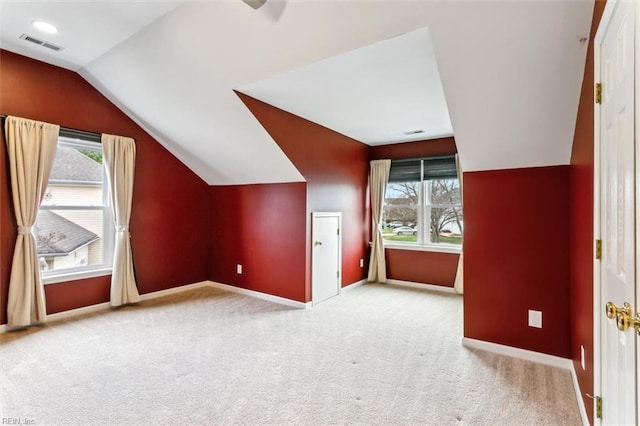 bonus room with vaulted ceiling, carpet floors, visible vents, and baseboards