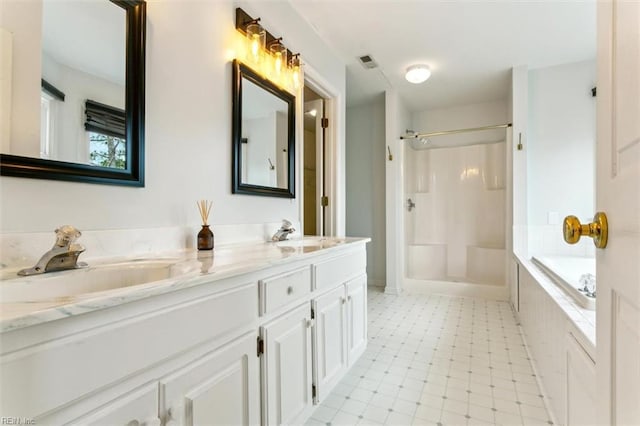 full bathroom with double vanity, visible vents, a sink, and tile patterned floors