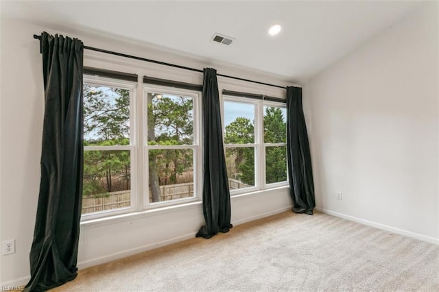 carpeted spare room featuring recessed lighting, visible vents, and baseboards