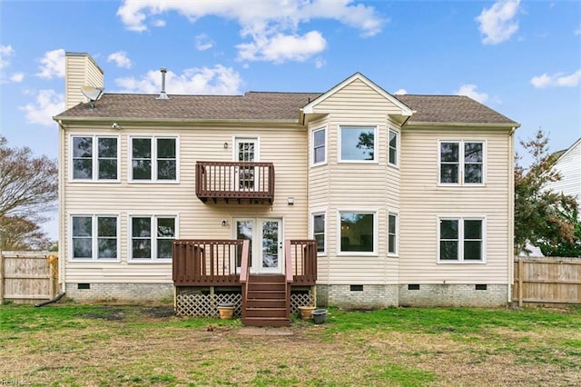 back of property with a balcony, crawl space, a fenced backyard, and a lawn