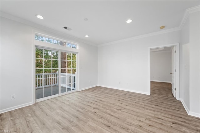 unfurnished room featuring visible vents, ornamental molding, and wood finished floors