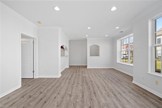 unfurnished living room with crown molding, light wood finished floors, and baseboards