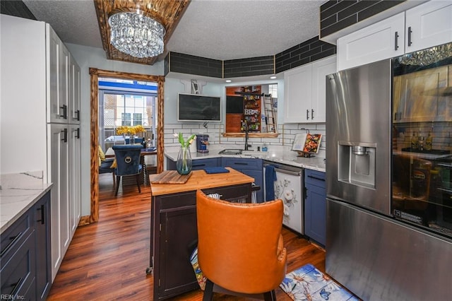 kitchen with white cabinets, decorative backsplash, stainless steel appliances, and dark wood-style flooring