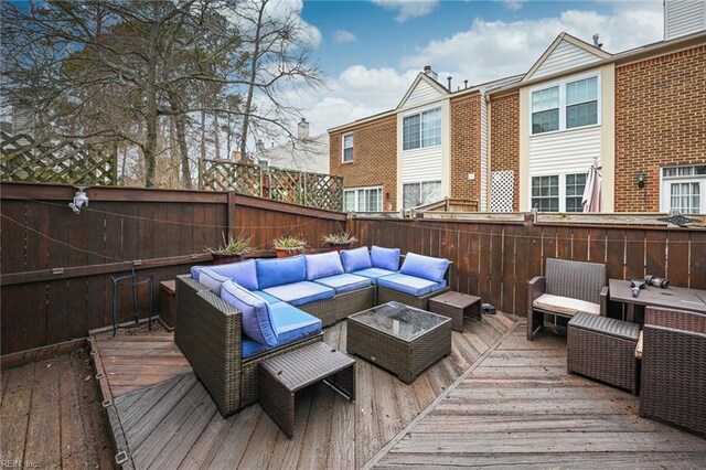 wooden deck featuring a fenced backyard and an outdoor living space