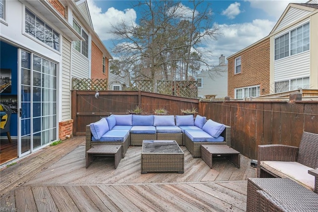 wooden deck featuring a fenced backyard and an outdoor hangout area