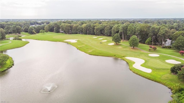 aerial view with view of golf course, a water view, and a forest view