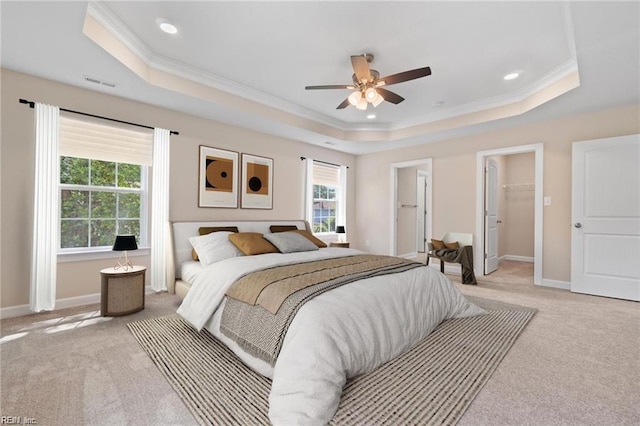 bedroom featuring light carpet, baseboards, and a raised ceiling