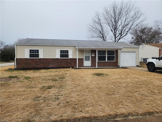 single story home with an attached garage, a front lawn, and brick siding