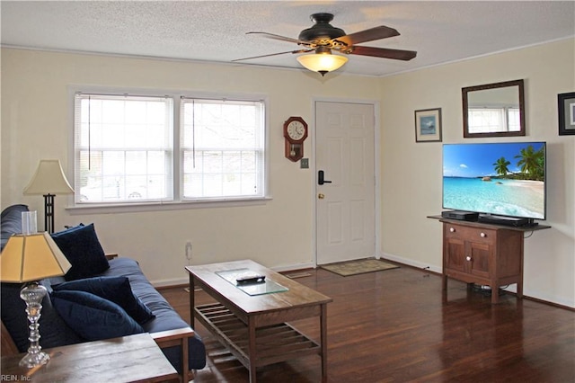 living area featuring ceiling fan, wood finished floors, baseboards, and a textured ceiling