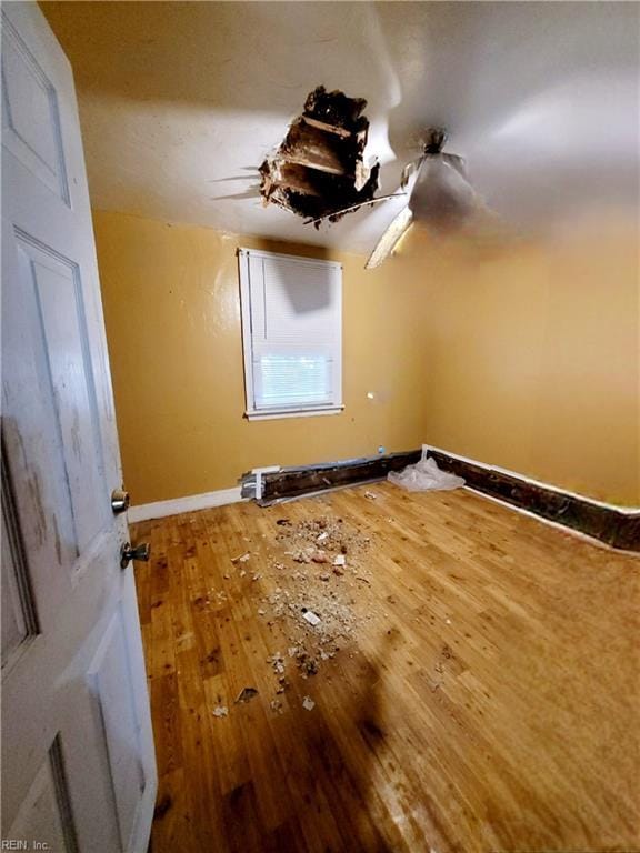 interior space with baseboards and hardwood / wood-style flooring