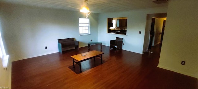 living area featuring dark wood finished floors and baseboards