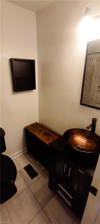 bathroom featuring tile patterned flooring and vanity