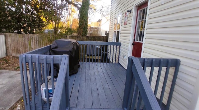 wooden deck featuring fence and area for grilling