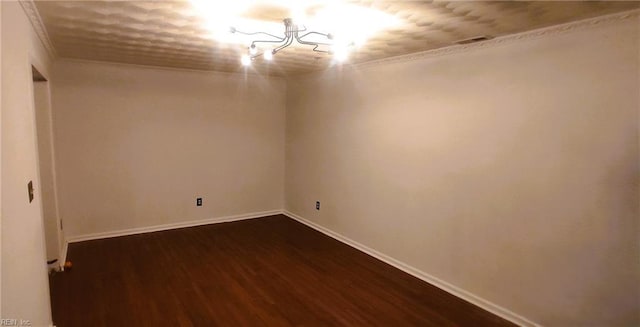 spare room with dark wood-style floors and baseboards