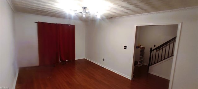 unfurnished room with stairs, baseboards, and wood finished floors