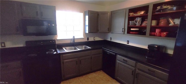 kitchen featuring dark countertops, black appliances, and a sink