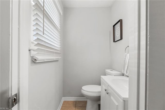 bathroom with baseboards, vanity, toilet, and tile patterned floors