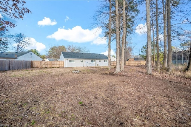 rear view of house featuring fence