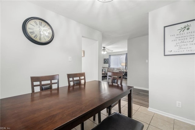 dining area with baseboards, a ceiling fan, and light tile patterned flooring