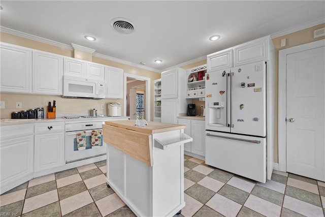 kitchen with visible vents, white cabinets, white appliances, and ornamental molding