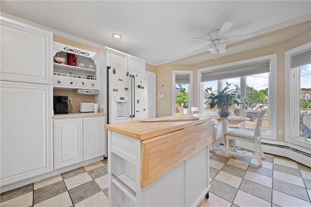 kitchen featuring wooden counters, a kitchen island, white refrigerator with ice dispenser, white cabinetry, and open shelves