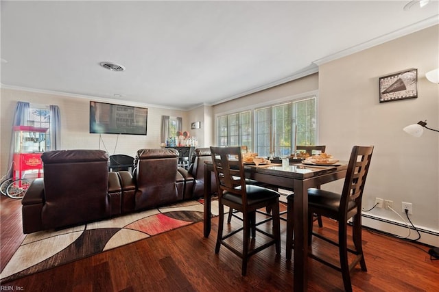 dining space featuring visible vents, wood finished floors, and crown molding